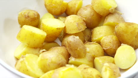 Patatas-Girando-En-Un-Recipiente-Blanco