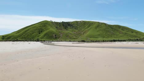 Behold-the-stunning-vista-of-a-hill-on-the-tranquil-beach,-where-nature-meets-serenity