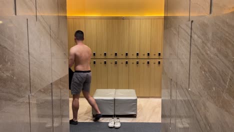 Timelapse-of-Asian-Millennial-Man-Undressing-in-Luxurious-Changing-Room