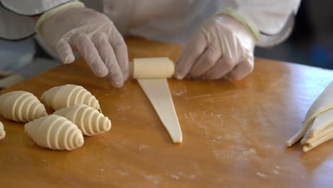 A-French-pastry-chef-rolls-out-croissant-dough-on-the-table