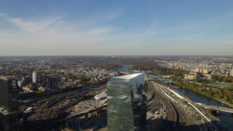 Aerial-view-of-a-helicopter-flying-over-the-Schuylkill-River,-fall-evening-in-Philadelphia,-USA