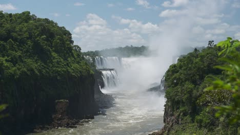 Espectacular-Vista-Lejana-De-Hermosas-Cascadas-En-Un-Pintoresco-Paisaje-Verde-Selvático,-Increíble-Grupo-De-Cascadas-Que-Caen-De-Enormes-Acantilados-En-Hermosas-Condiciones-Soleadas-En-Las-Cataratas-Del-Iguazú,-Argentina