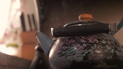 Close-up-shot-of-steaming-hot-old-teapot-kettle-in-slow-motion