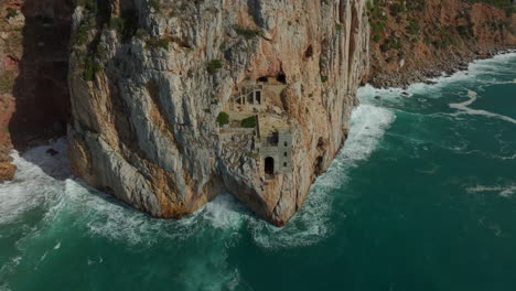 Porto-Flavia:-fantastic-aerial-shot-of-the-old-mining-port-on-the-island-of-Sardinia-and-the-waves-hitting-the-cliff