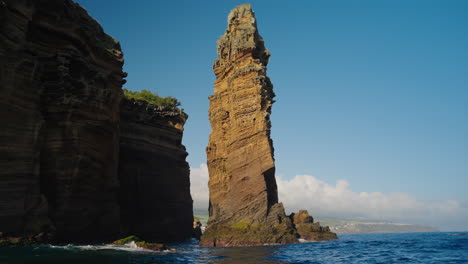 Slow-motion-shot-of-beautiful-tropical-coastline-cliffs-from-sea-level
