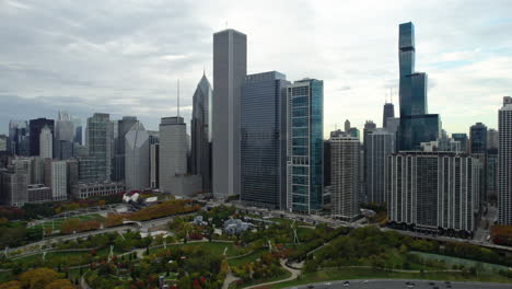 Aerial-pan-shot-of-skyscrapers-of-the-New-Eastside,-fall-foliage-in-cloudy-Chicago