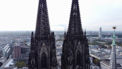 Close-Up-Gothic-Twin-Spires-of-Cologne-Cathedral-Aerial-Dolly-Out