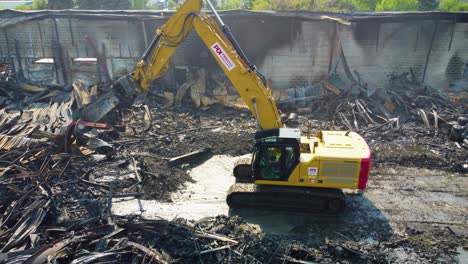 Tractor-removing-debris-from-major-industrial-destruction-after-fire