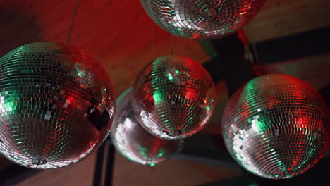 Close-up-of-disco-balls-reflecting-vibrant-multi-colored-lights