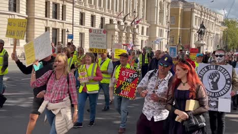 Protesters-peacefully-marching-up-London-street-yelling-slogans-and-carrying-placards