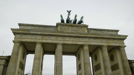 POV-shot-walking-in-front-of-the-Quadriga-statue-on-the-Brandenburg-Gate-in-cloudy-Berlin