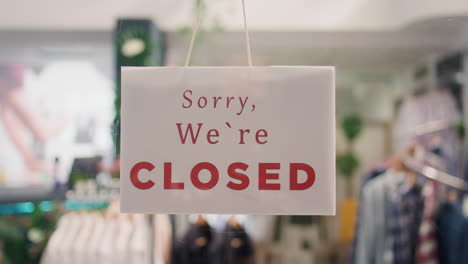 Closed-sign-on-clothing-store-door