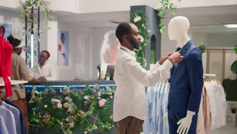 Retail-clerk-puts-blazer-on-mannequin