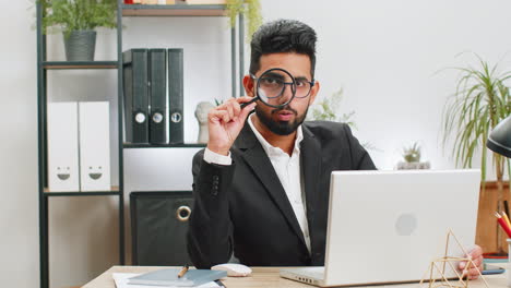 Business-man-holding-magnifying-glass-near-face,-looking-with-big-zoomed-eye,-searching,-analyzing