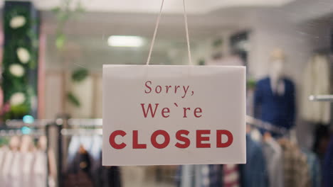 Closed-sign-on-elegant-clothing-store