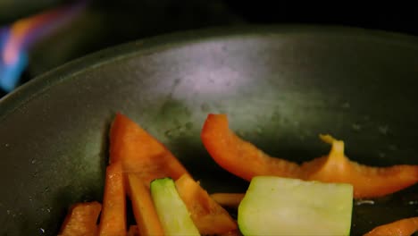 Backwards-dolly-of-fresh-vegetables-in-hot-frying-pan
