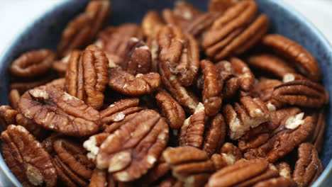 Pecan-nuts-rotating-in-blue-bowl