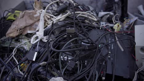 Large-stack-of-recycling-electronic-waste,-different-cables-and-wires-with-adapters,-dedication-to-environmental-protection-and-the-pursuit-of-a-cleaner-and-more-sustainable-technological-landscape