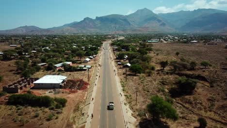 Endless-Road-Along-Moroto-Countryside-Town-With-Mountain-Background-In-Karamoja,-Uganda,-East-Africa