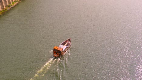 Wooden-Ferry-Boat-Cruising-In-The-Douro-River-In-Porto,-Portugal