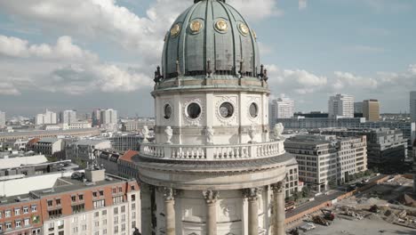 Aerial-close-up-of-French-Cathedral-tower-in-Berlin,-cloudy-day-in-east-Germany