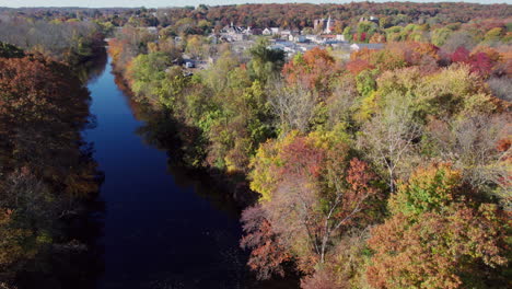 Aerial-view-of-the-Pawtuxet-River-in-the-fall,-West-Warwick-in-the-distance