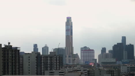 A-view-of-Bangkok's-cityscape-shows-Baiyoke-Tower-on-a-gloomy,-cloudy-day