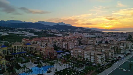 Aerial-drone-forward-moving-shot-over-beautiful-sunrise-over-the-Malaga-city,-Andalusia,-Spain-at-dawn