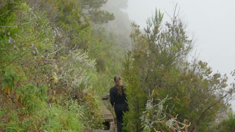 Adventurous-woman-walking-on-extreme-hiking-trail-in-Tenerife