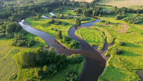 a-cinematic-view-from-a-drone-that-flies-over-a-river-that-meanders-through-the-countryside