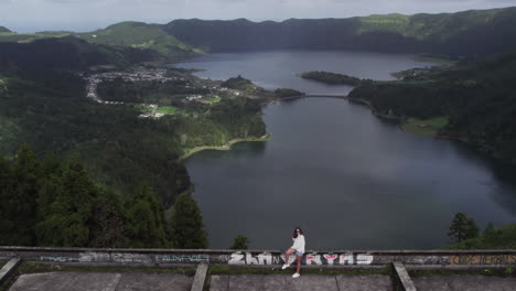 Woman-overlooking-Sete-Cidades-Lagoon-from-Monte-Palace,-São-Miguel,-Azores