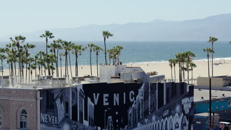 Long-lens-shot-of-Venice-Beach-with-building-and-mural-in-bottom-of-frame