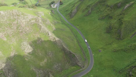 Motorhome-driving-down-narrow-road-through-Winnats-Pass,-Peak-District,-England