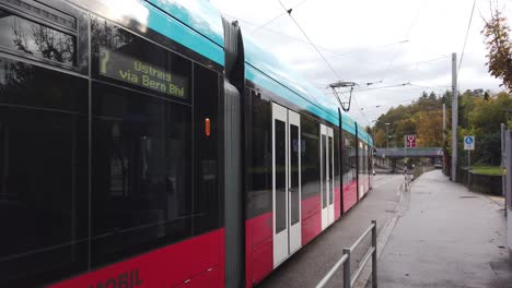 A-Red-Tram-Closeup-Traveling-Shot-in-Streets-of-Bern-Switzerland-Transportation