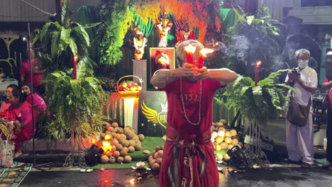 Devotees-pray-and-perform-a-ritual-during-the-Navaratri-Festival,-celebrating-the-Goddess-Parvati-in-Bangkok,-Thailand