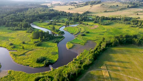 cinematic-drone-view-as-it-rotates-and-captures-a-river-flowing-through-the-landscape-from-above
