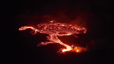 Aerial-wide-view-of-an-erupting-volcano-at-night