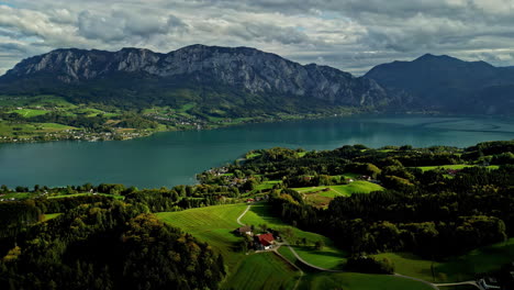 Aerial-overview-of-rural-nature-and-lake-Attersee,-fall-day-in-Austria