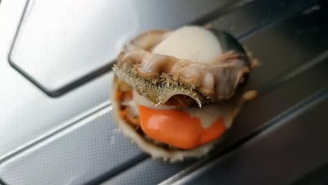 Freshly-baked-exotic-Bay-scallop-edible-saltwater-clam-without-it's-shell-on-aluminium-kitchen-surface