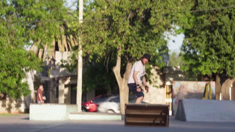 A-redhead-man-jumps-off-a-quarter-pipe-ramp-on-his-skateboard