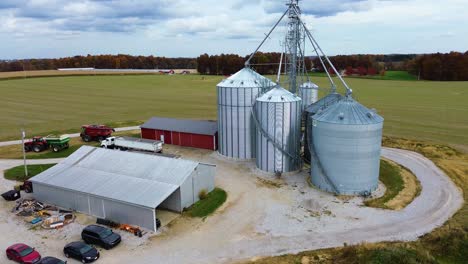 Midwest-farm-with-grain-silos-and-barns,-aerial-drone