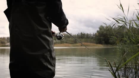 Hands-of-a-fisherman-with-a-spinning-rod-in-hand-super-slow-Motion