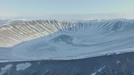 Aerial-view-of-hikers-at-Hverfjall-volcano-and-crater-in-Iceland-in-winter,-sunny-day,-near-Lake-Mývatn