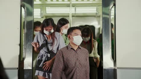 Crowd-of-people-wearing-face-mask-on-a-crowded-public-subway-train-travel
