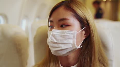 Traveler-wearing-face-mask-while-traveling-on-commercial-airplane-.