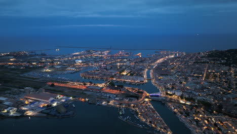Aerial-night-tour:-Sète's-illuminated-canals,-thriving-port,-and-poetic-heritage