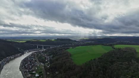 Flying-over-Dinant,-one-witnesses-a-city-where-the-Meuse-River-fuels-history-and