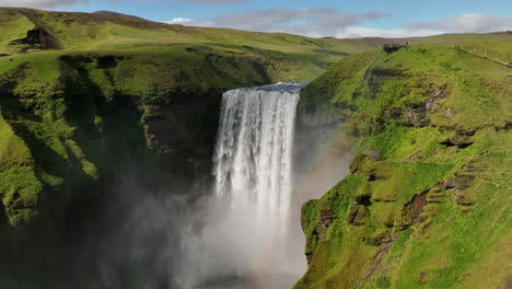 Gran-Cascada-Gigante-En-Cámara-Lenta-Aérea-De-Islandia-Con-Día-Soleado-De-Arco-Iris
