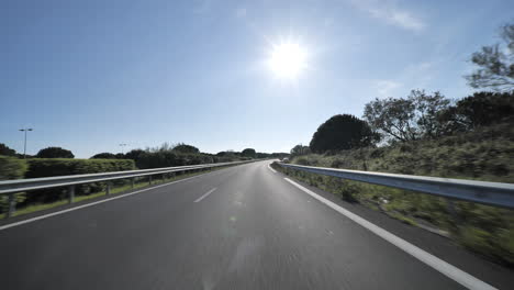 driving-on-empty-highway-with-vegetation-on-the-side-France-Montpellier