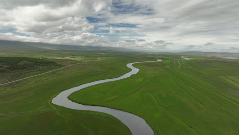 Beautiful-winding-river-in-Iceland-countryside-aerial-shot-cloudy-day
